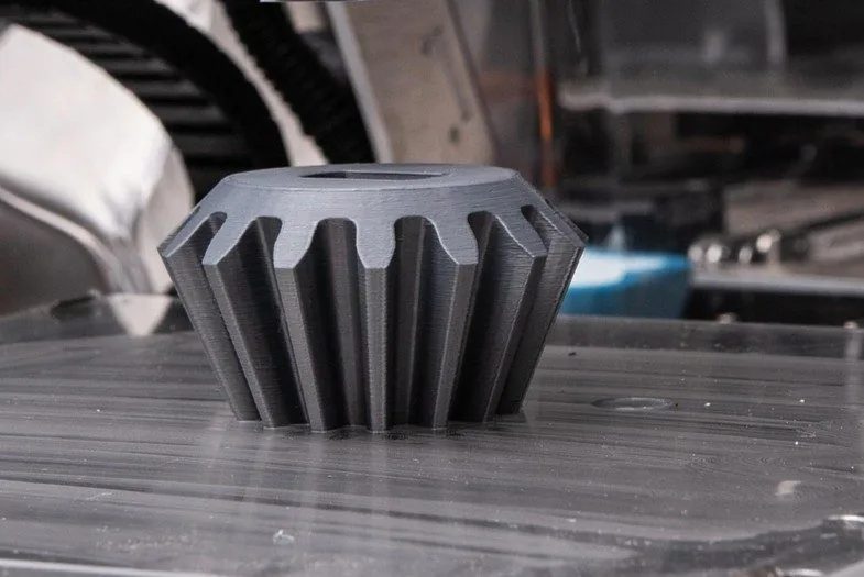 Engranaje cónico fabricándose en una impresora 3D de cámara cerrada